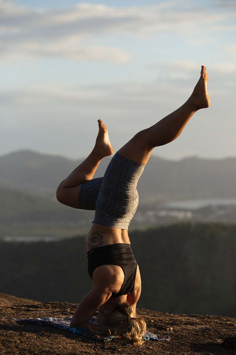 sport woman doing yoga on hill sports